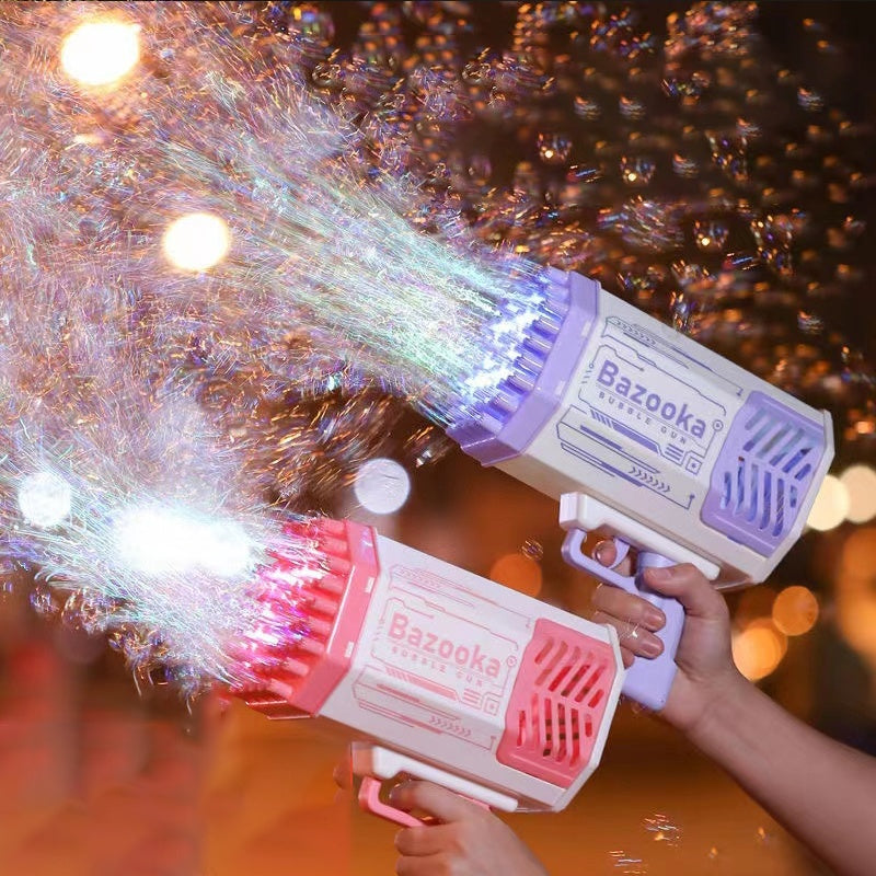 Pink and blue bubble gun toy held by hands, shooting colorful soap bubbles in low light