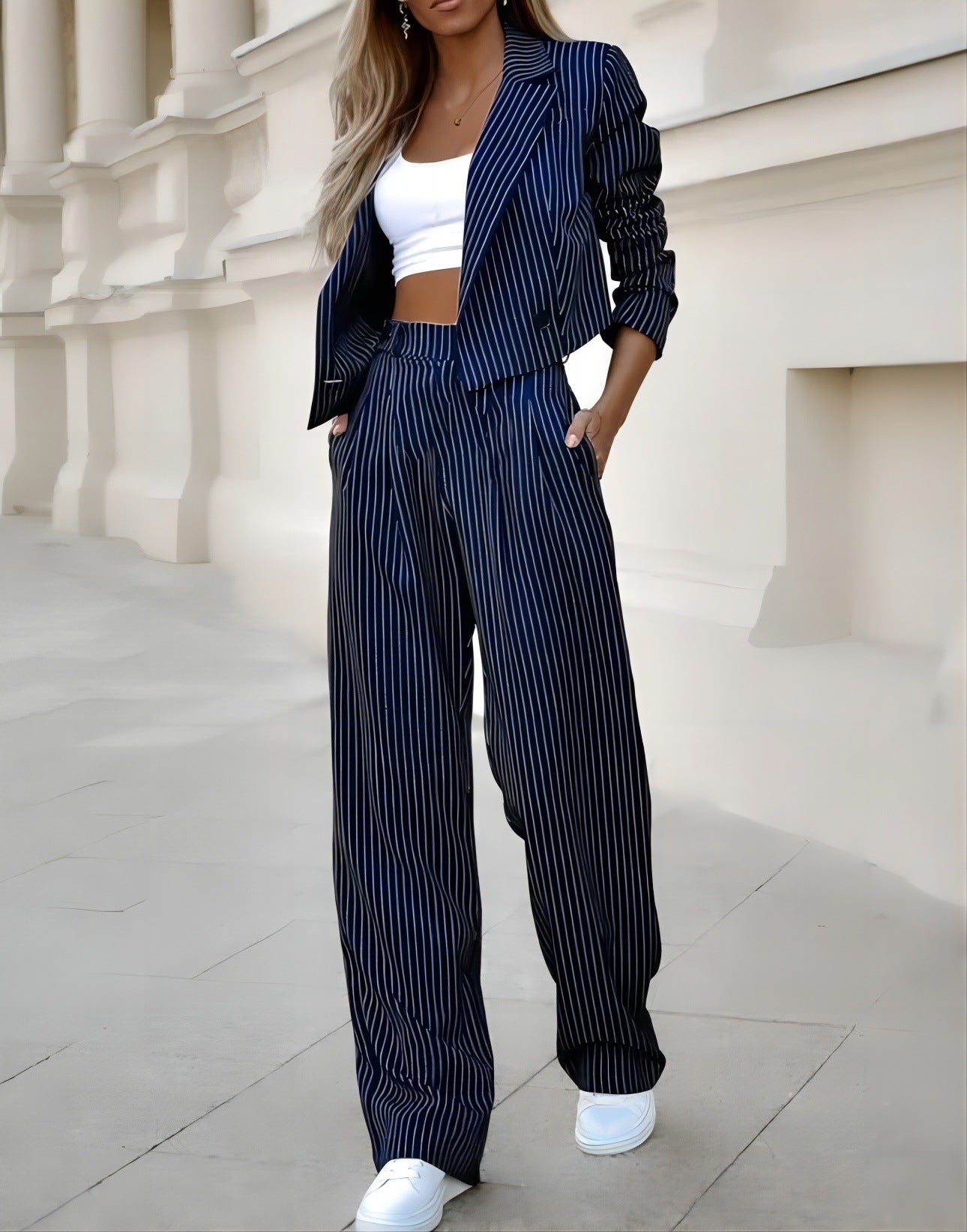 Navy pinstripe blazer and straight-leg pants set over a white crop top