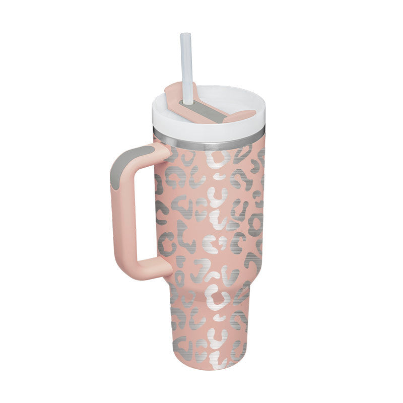 Insulated tumbler with handle, pink leopard print, straw and lidded top.