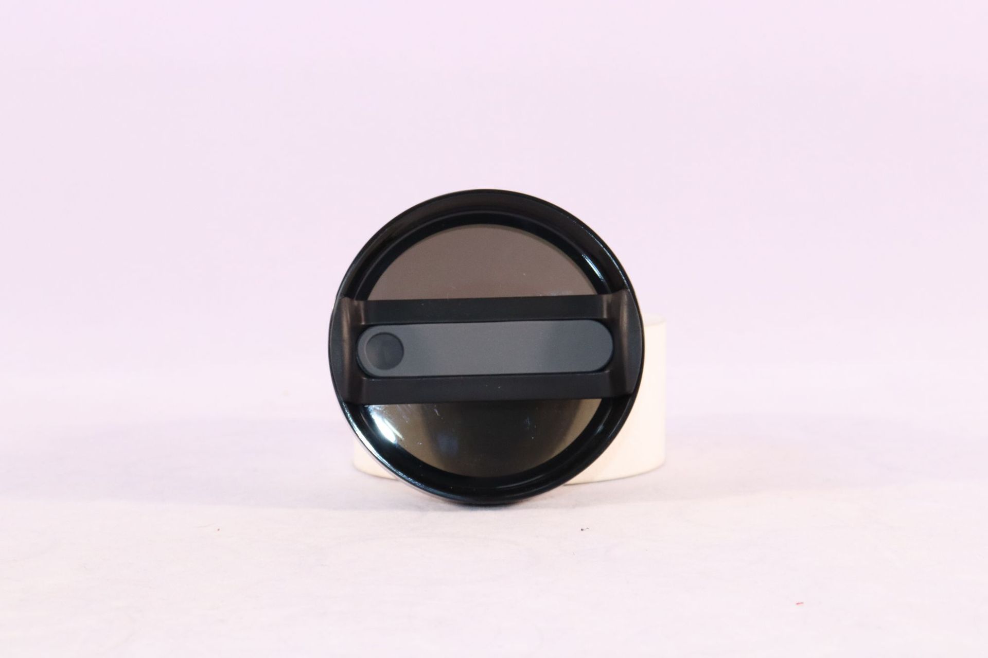 Tumbler lid with straw opening and dark slider, round black top disc.