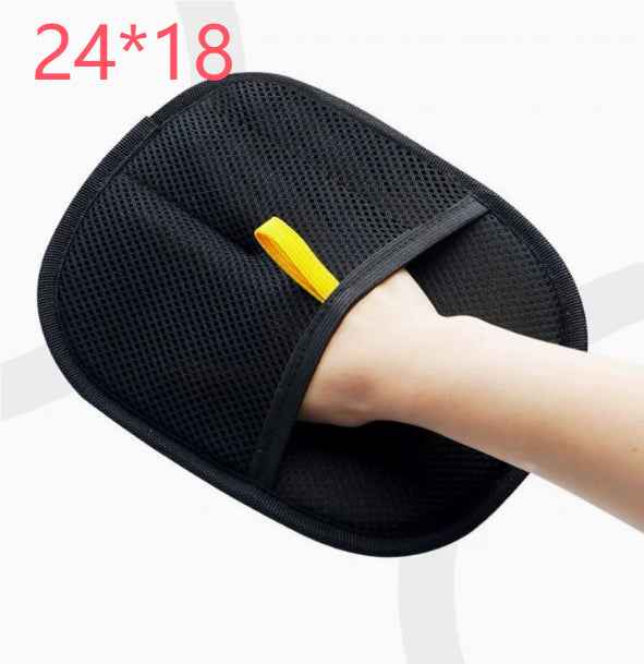 Pet hair remover glove, black mesh grooming mitt with yellow tab, on arm