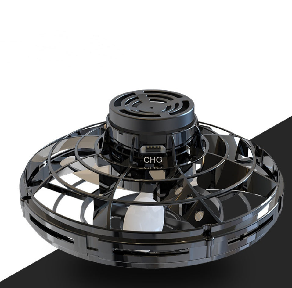 Black UFO spinning toy drone with CHG label and vented top