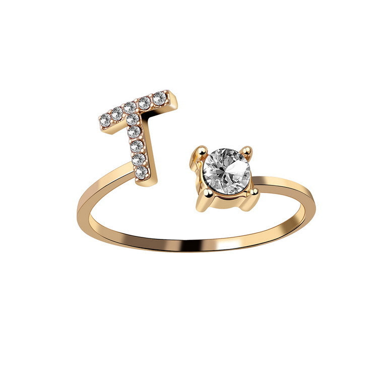 Gold adjustable initial letter ring with pave letter detail and oval center stone.