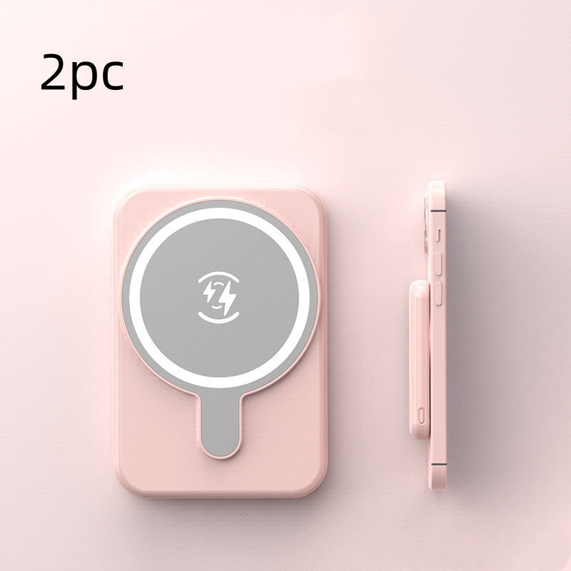 Set of two pink mini magnetic wireless power banks with charging icon