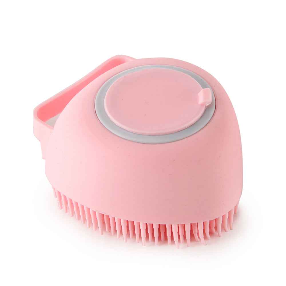 Pink silicone pet grooming brush with oval massage pad and front bristle row
