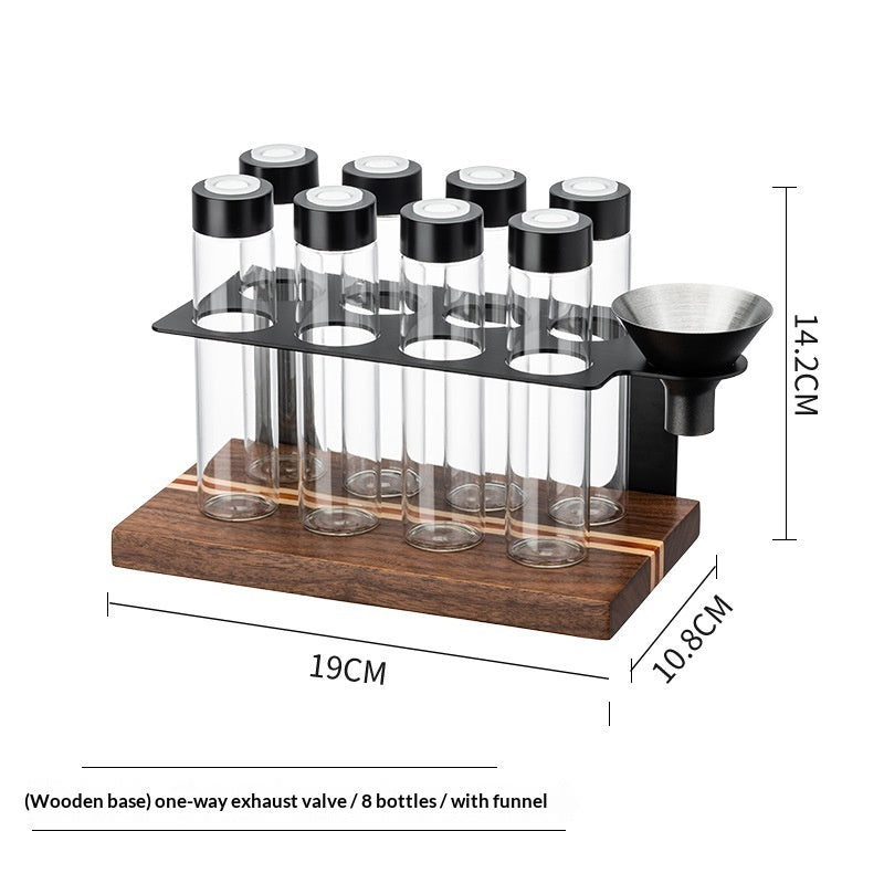 Bottle display rack for 8 bottles with wooden base and funnel; clear vials with black caps.