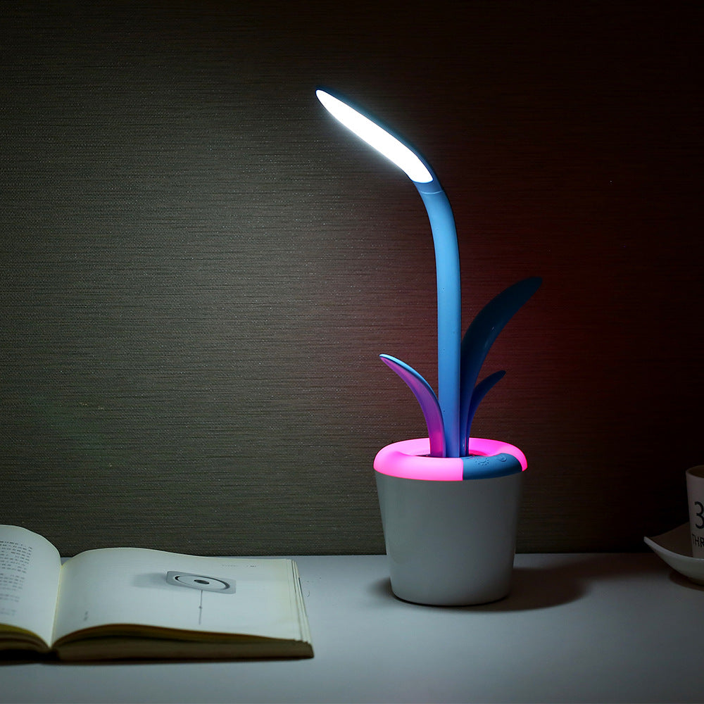 LED table lamp with glowing blue stem and purple accents; white pot with pink rim