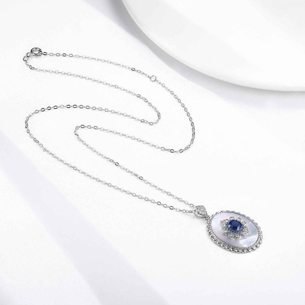 Sapphire oval pendant necklace on silver chain with blue center stone