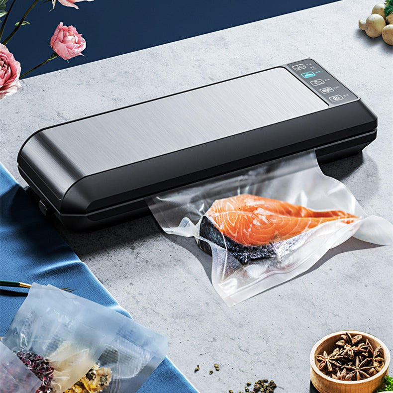Black home vacuum sealer sealing produce bag with salmon fillet, control panel visible