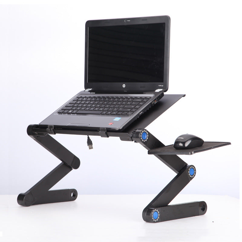 Black laptop stand with mouse pad and folding legs, propping an open laptop