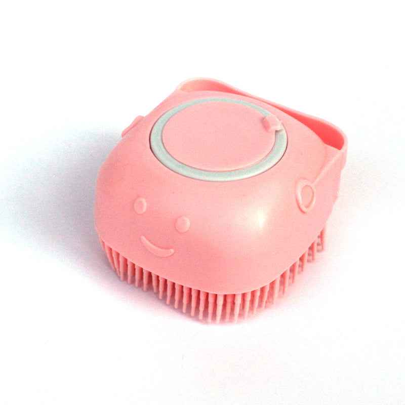Pink silicone pet grooming brush with oval massage pad and short bristle tips