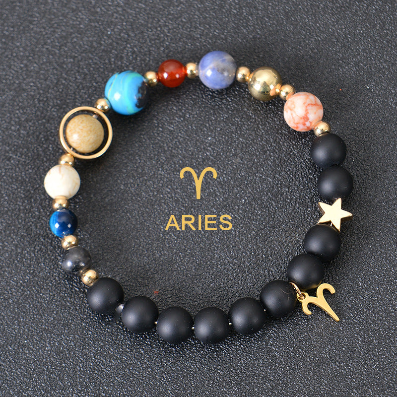 Aries zodiac beaded bracelet with black matte beads, colorful stone beads, and gold star charms