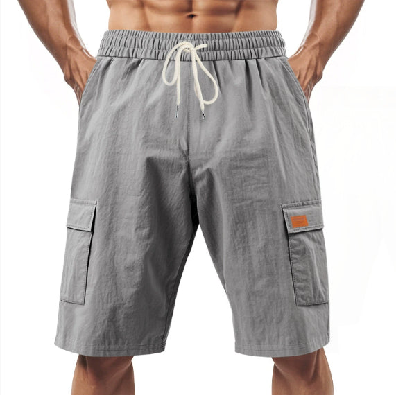 Gray linen cargo shorts with elastic waistband and drawstring, side flap pockets
