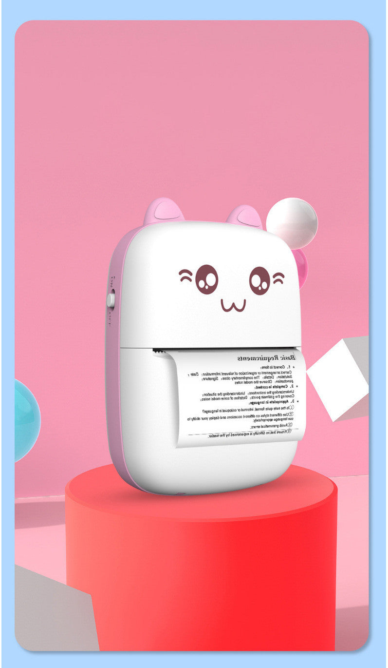 Mini label printer with cat face, pink body and white paper roll extended