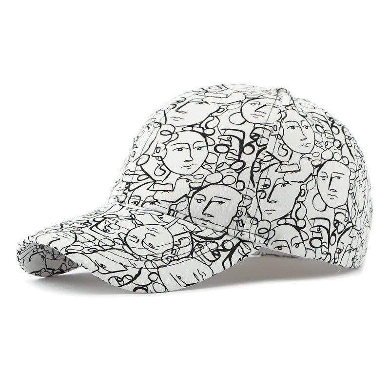 Retro peaked cap with black graffiti-style face print on white fabric