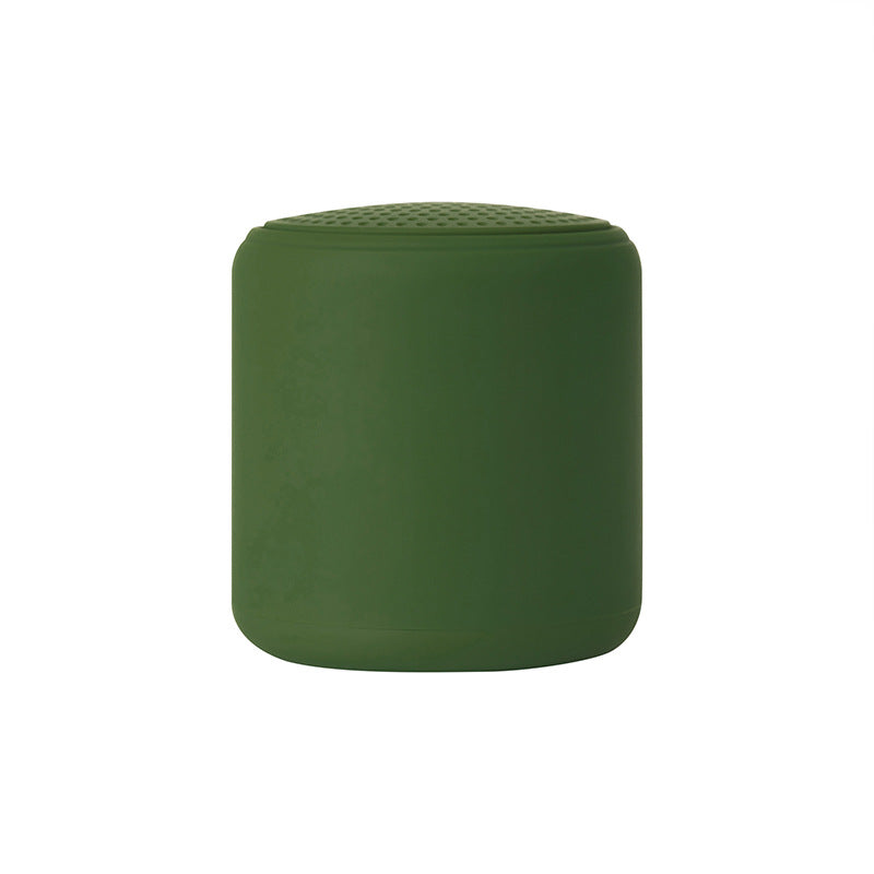 Portable wireless mini speaker, green cylinder with textured perforated top grille