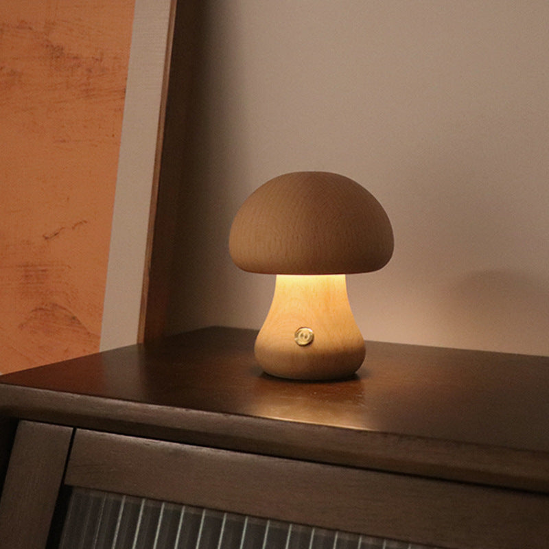 Light wooden mushroom LED night light with rounded cap, warm glow on shelf
