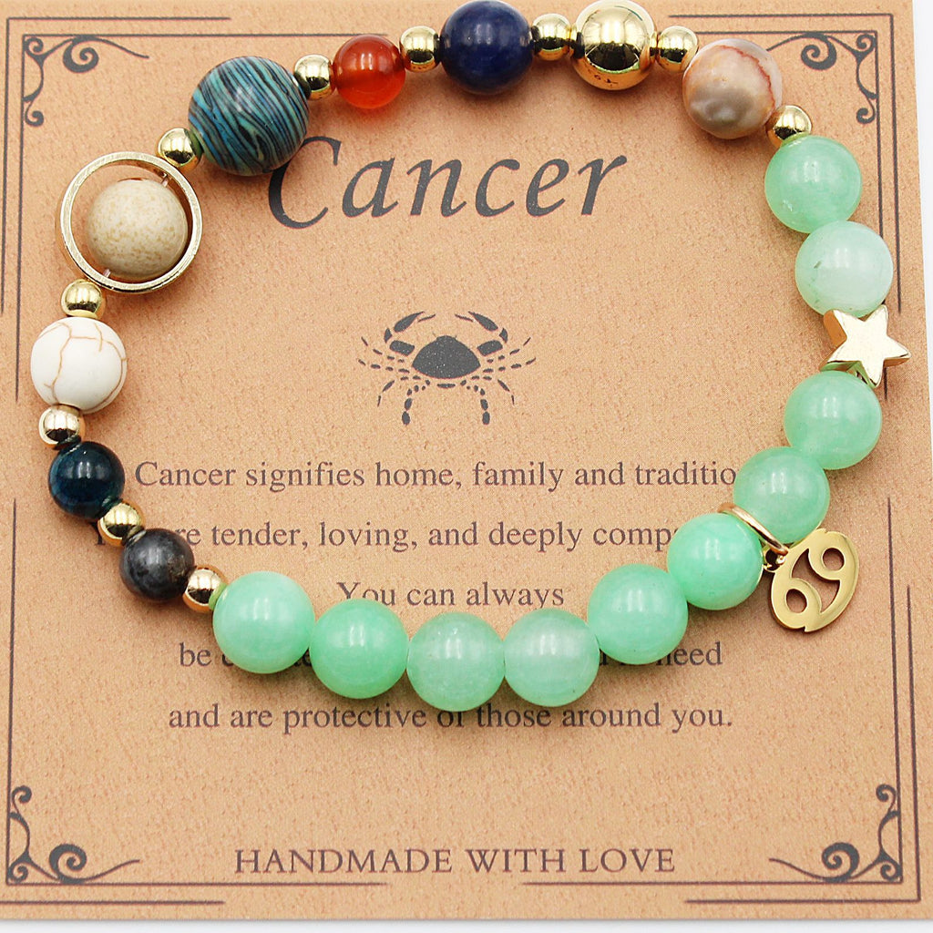 Beaded zodiac bracelet with mint green beads, gold spacers, star charm and crab charm