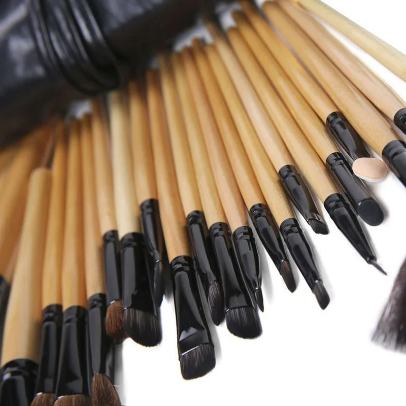 Assorted makeup brushes with black ferrules and light wood handles, soft bristles