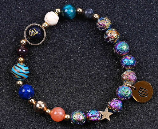 Beaded bracelet with blue, purple, and orange beads, star charm, and round zodiac pendants