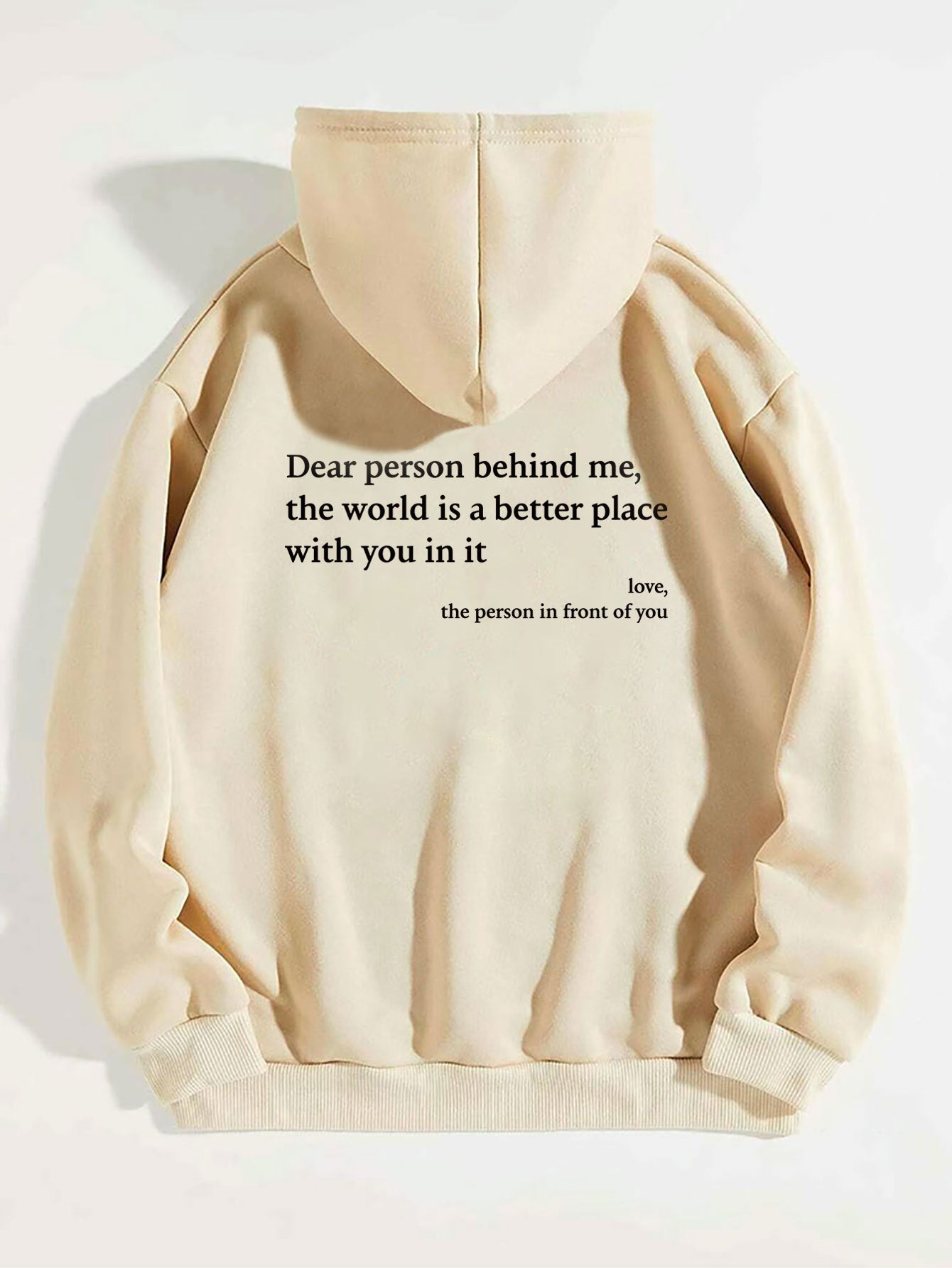 Beige plush hoodie with hood, drawstrings, kangaroo pocket, and printed back message