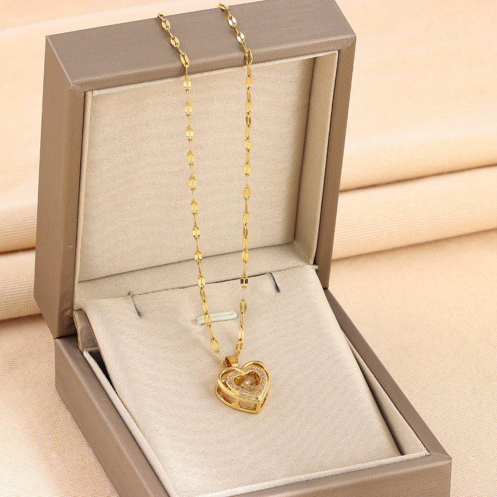 Double-layer heart pendant necklace with gold-toned links, resting in gift box