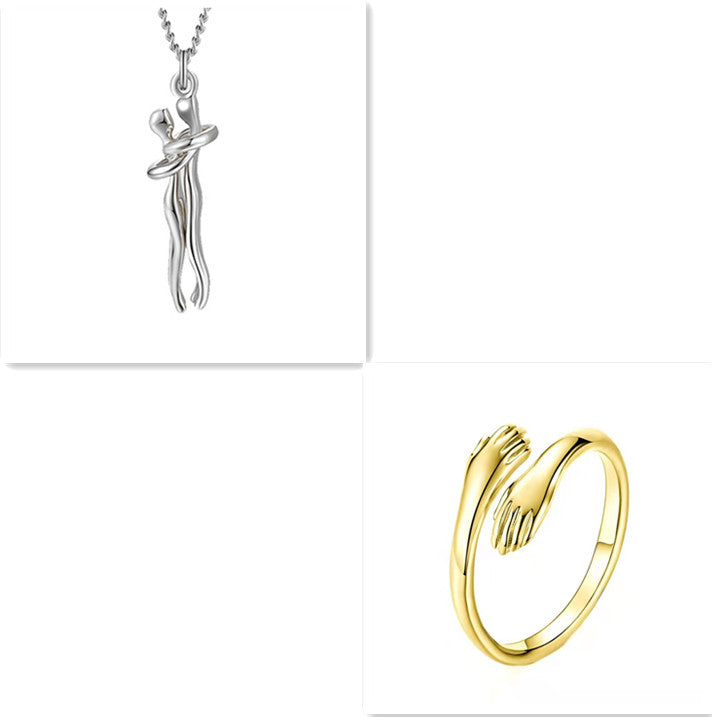 Silver hug-pendant necklace with silver chain and gold-tone ring, polished metal