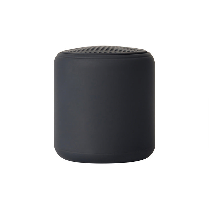 Portable wireless mini speaker, dark gray cylinder with perforated top grille