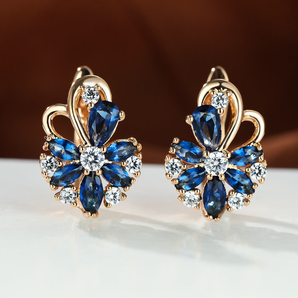 Flower drop-shaped zircon earrings with blue and clear stones in gold-tone settings