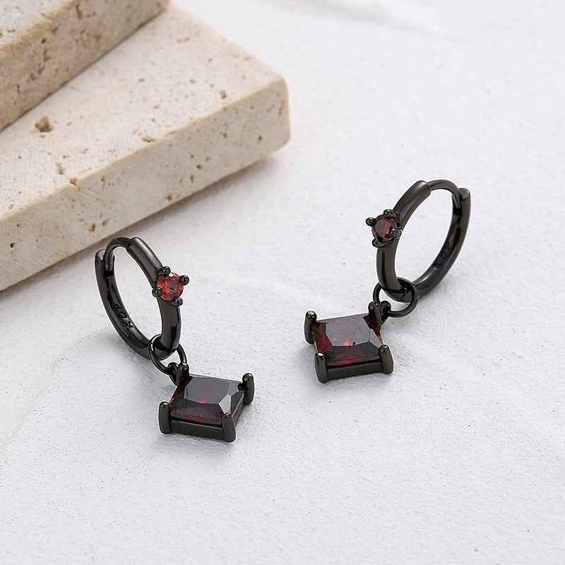 Black gold hoop earrings with red crystal square dangles