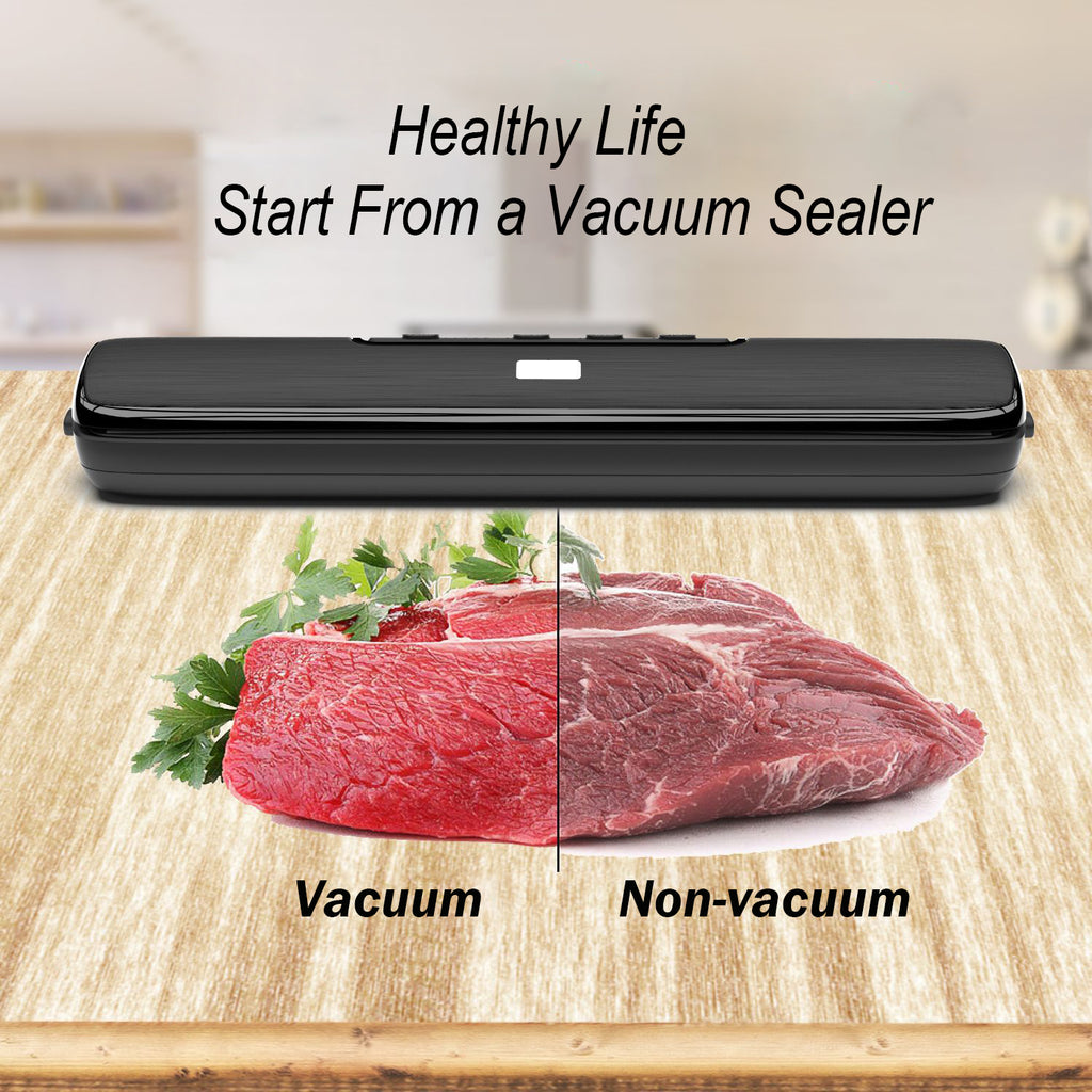 Black vacuum food sealer with vacuum-sealed raw meat on a wooden board