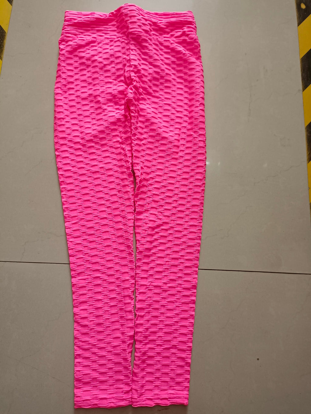 Hot pink scrunch leggings with textured lift pattern, full-length view