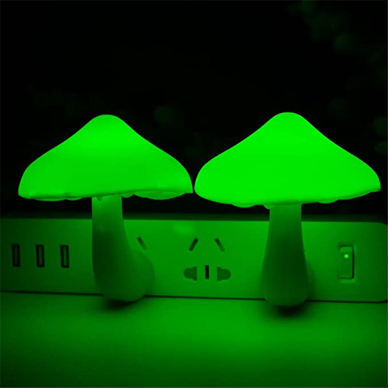 Two plug-in mushroom LED night lights with green glowing caps on outlet strip