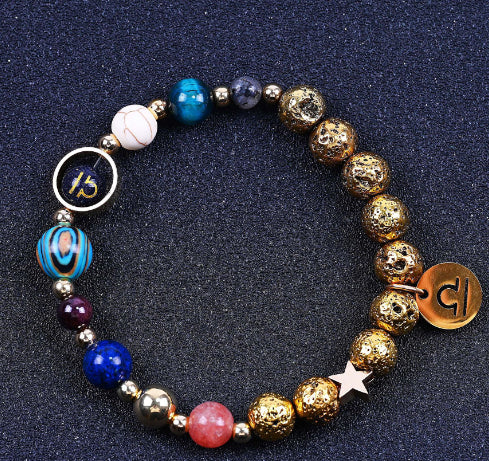 Beaded bracelet with gold beads, blue stones, and zodiac discs with heart and star charms