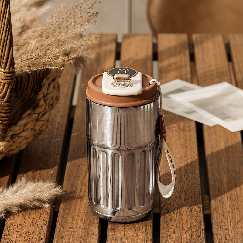 Stainless steel vacuum insulated coffee mug thermos with digital lid and brown trim, strap