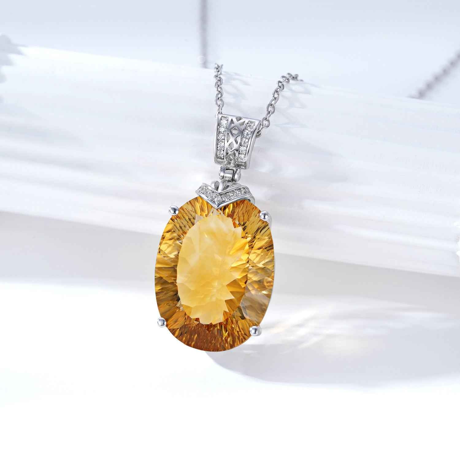Silver necklace with yellow oval gemstone pendant and top crystal setting