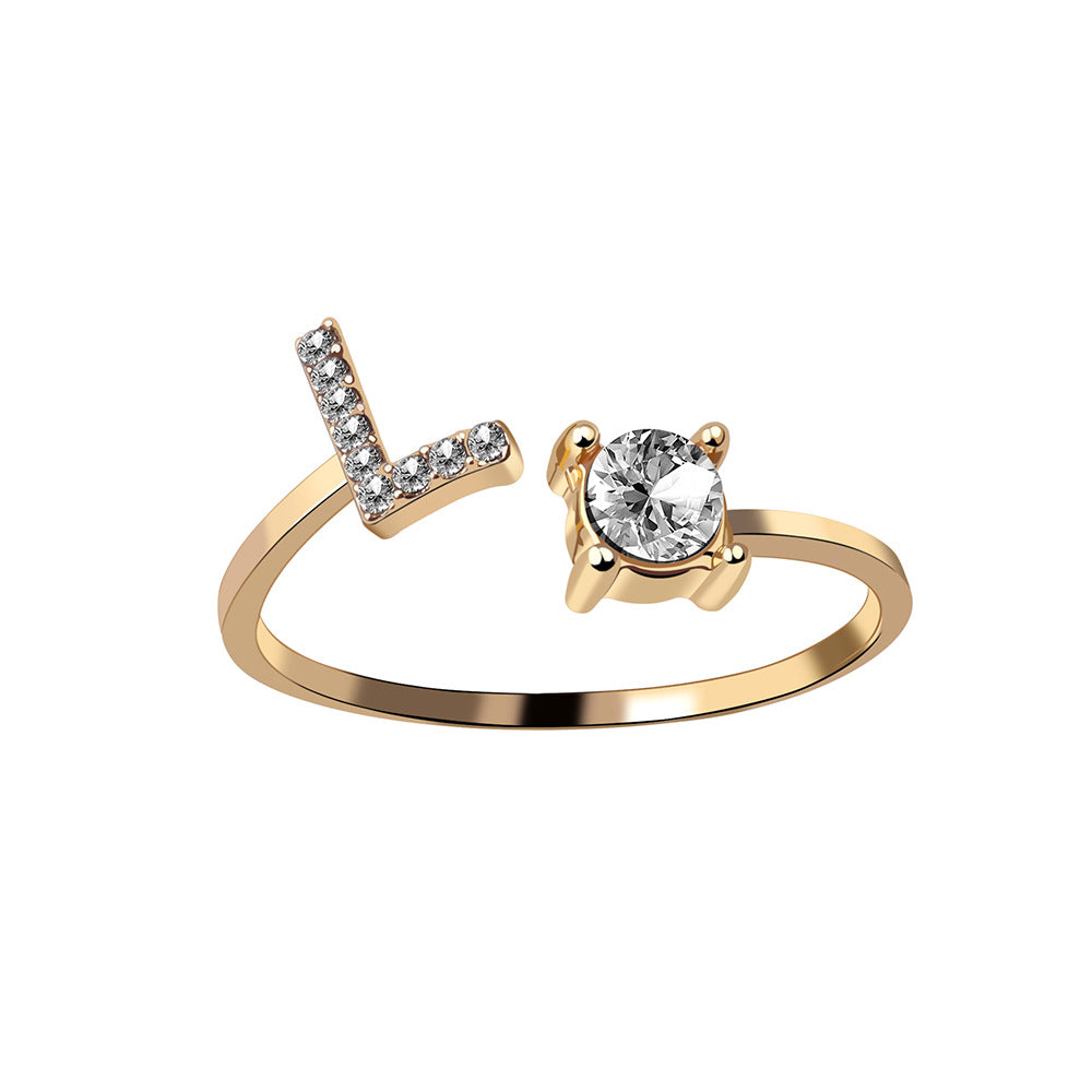Adjustable initial letter ring with crystal initial and round center stone, gold-tone band