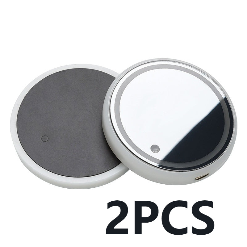 Two round LED light-up coasters with dark gray bases and clear top faces