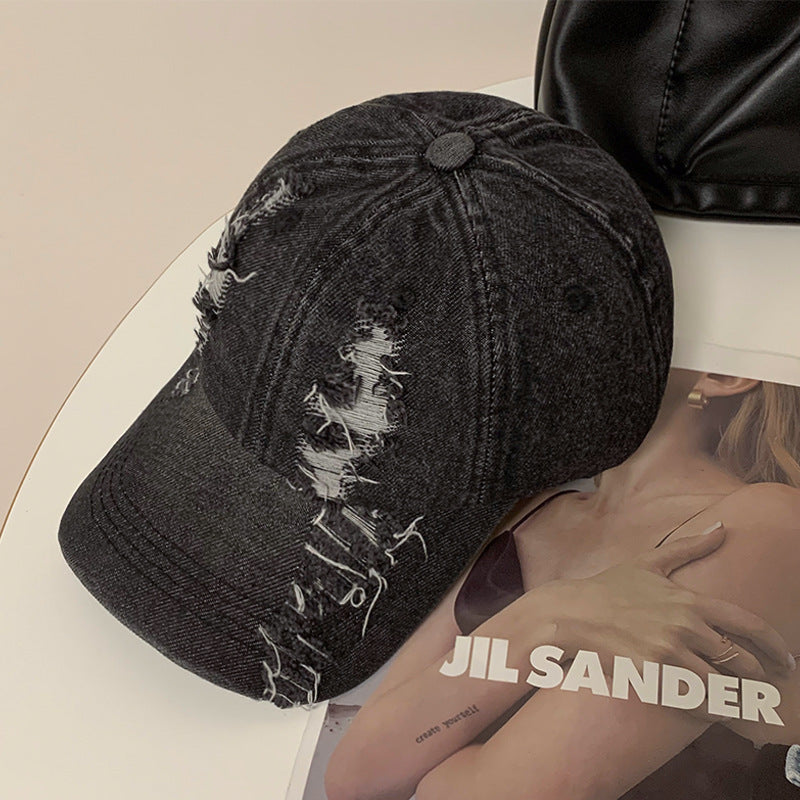Black denim baseball cap with frayed ripped front panel