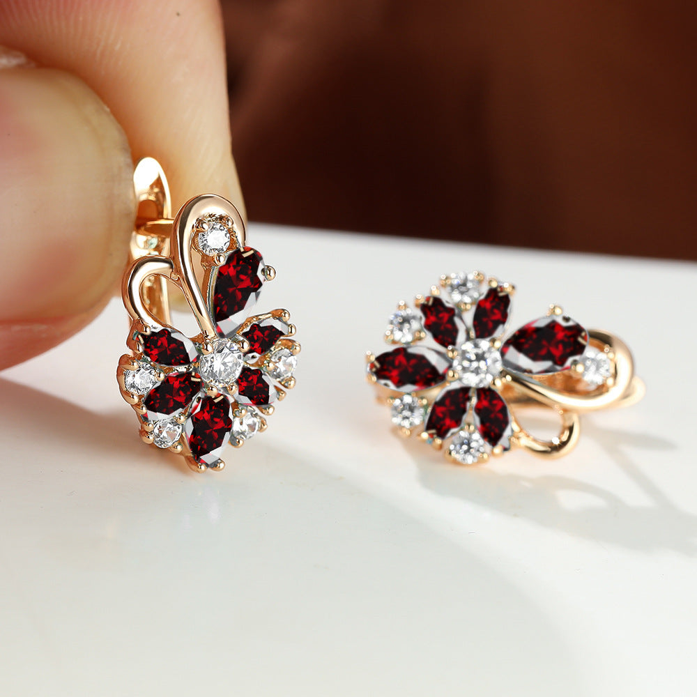 Flower drop-shaped zircon earrings with red and white stones in gold-tone settings