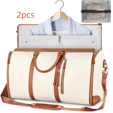 White and brown foldable travel duffle bag with front zipper, tassel pulls, shoulder strap