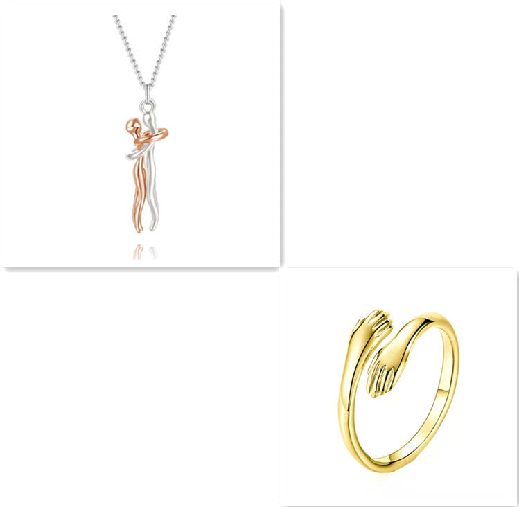 Rose-toned hug-pendant necklace with silver chain and gold-tone ring, polished metal