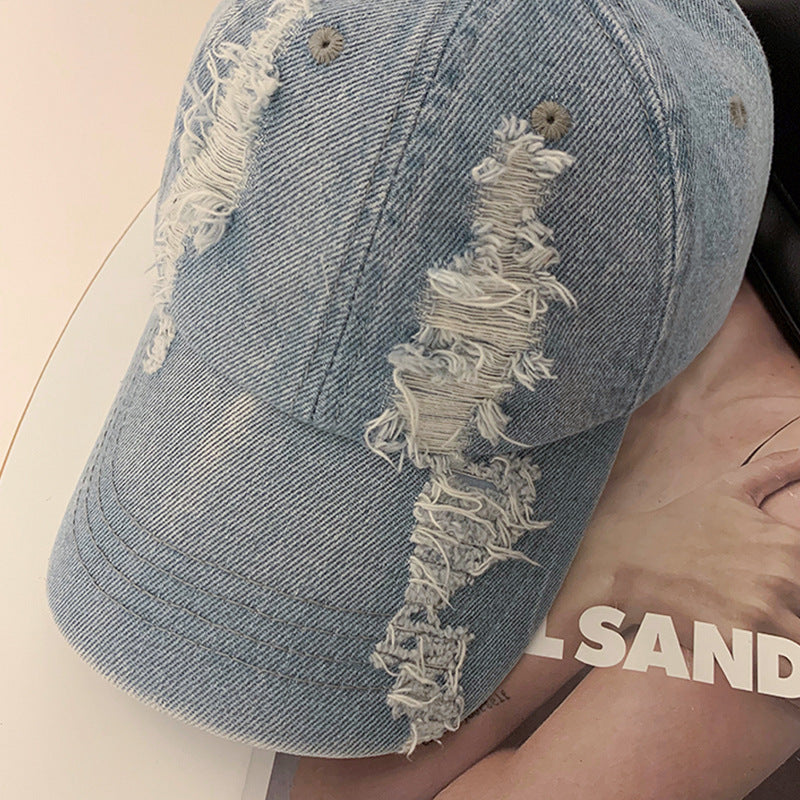 Light blue denim baseball cap with frayed ripped appliqué on the side