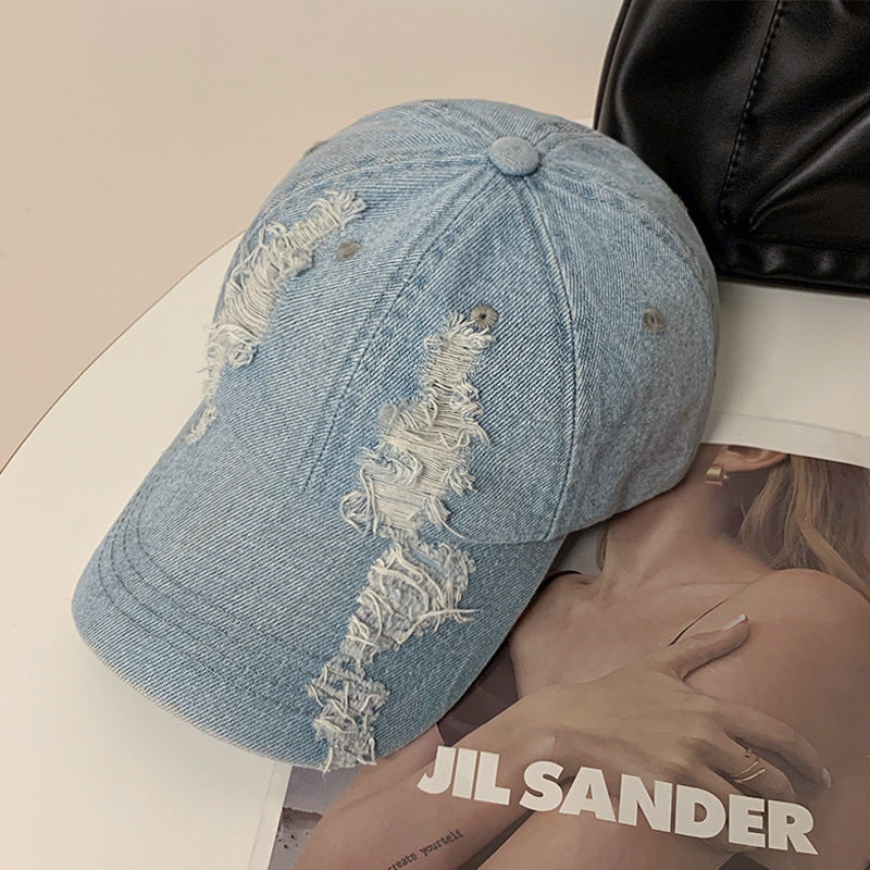 Light blue denim baseball cap with vertical ripped graphic on the front