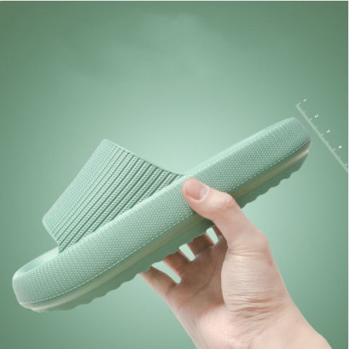 Light mint slide slippers with open toe and cushioned textured footbed.