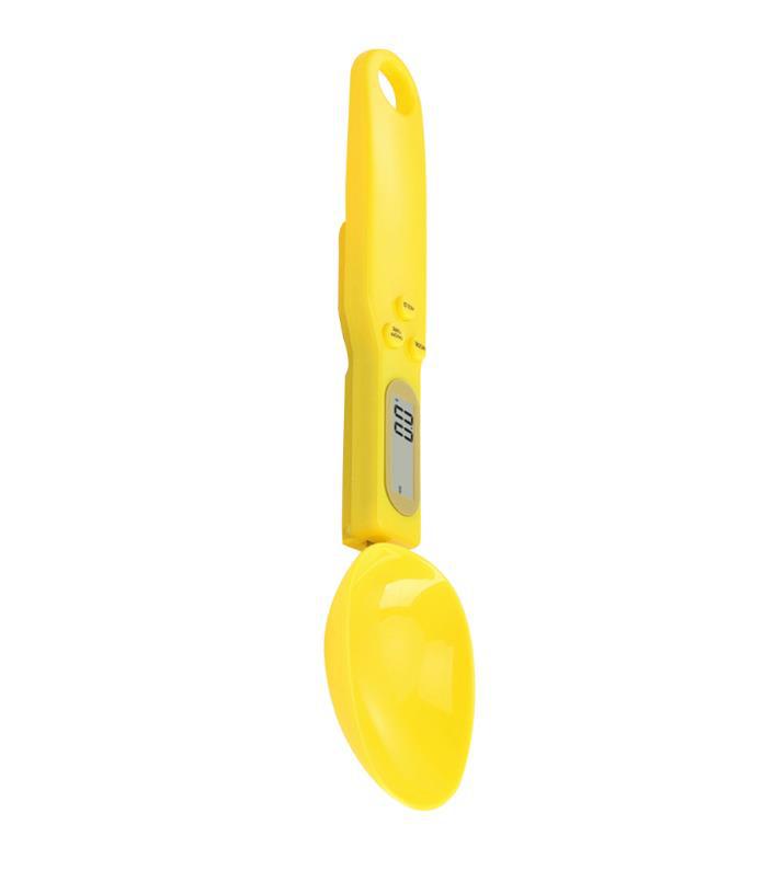 Yellow measuring spoon scale with oval spoon bowl and LCD display.