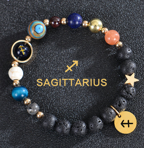 Zodiac bracelet with black lava beads and Sagittarius charm, star and disc charms.