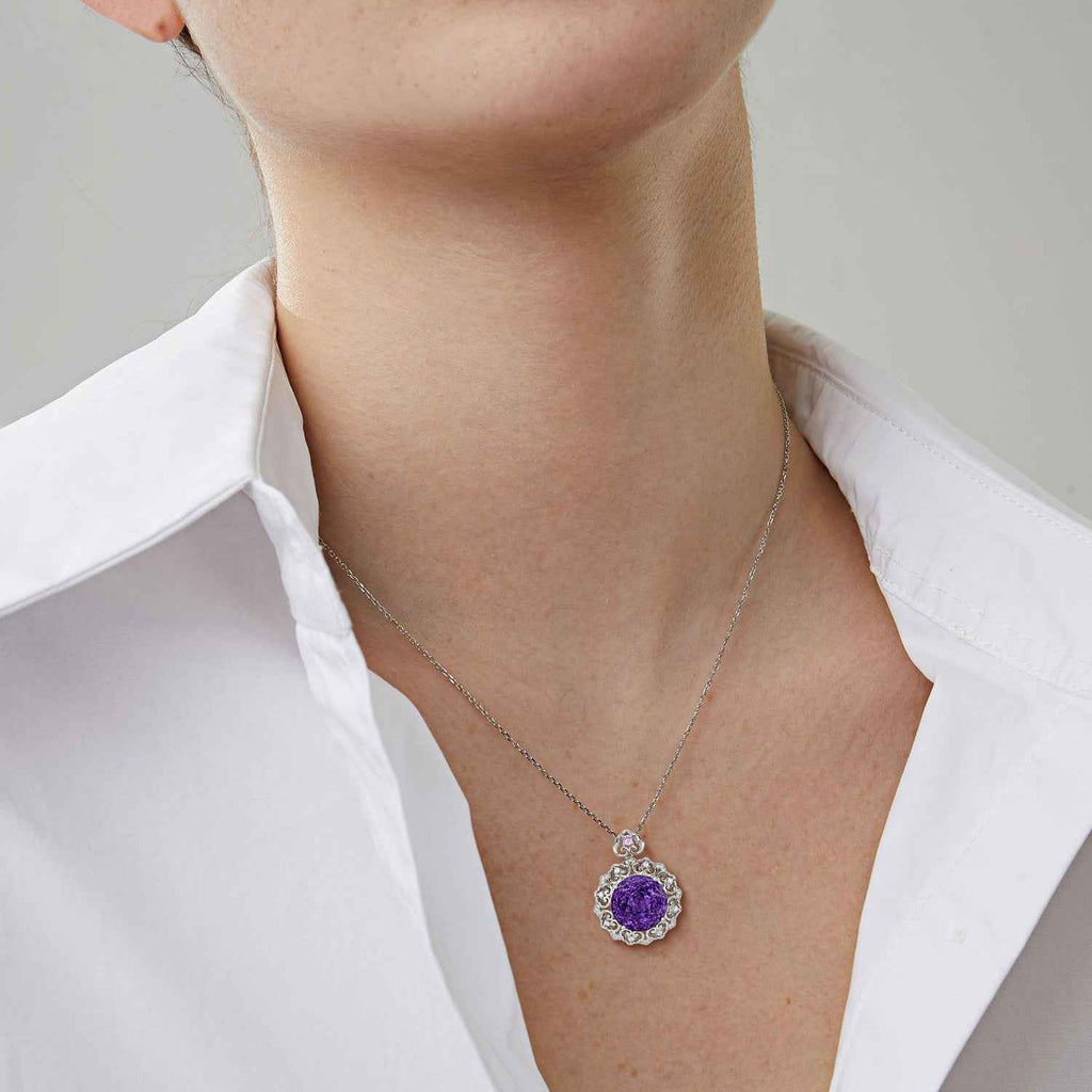 Silver amethyst pendant necklace on neckline, round purple stone in filigree