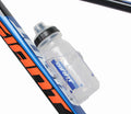 Clear-sided cycling water bottle with flip-top cap, angled view on blue bike frame