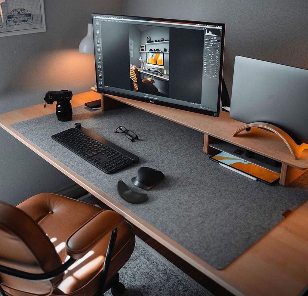 Ergonomic mouse wrist rest on desk, dark gray contoured cushion